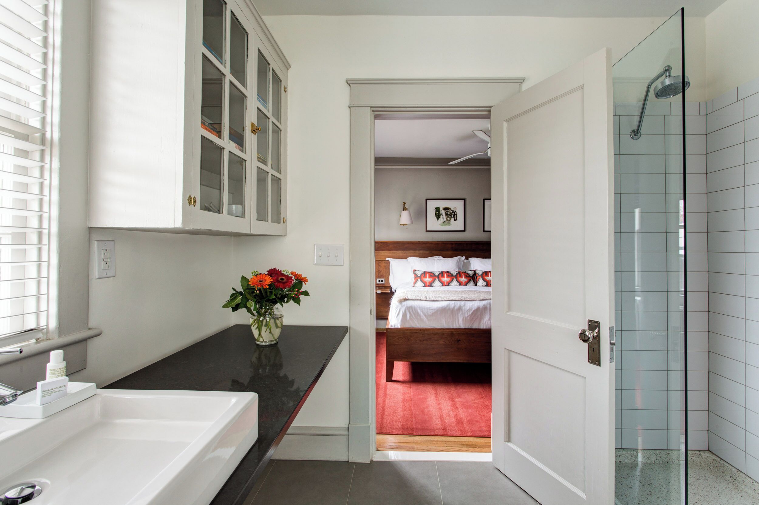A bathroom with a bathtub, a shower, and a glass-enclosed shower area.