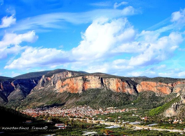 A mountainous landscape with a town nestled at the base. - Agroktima (South Kynouria)