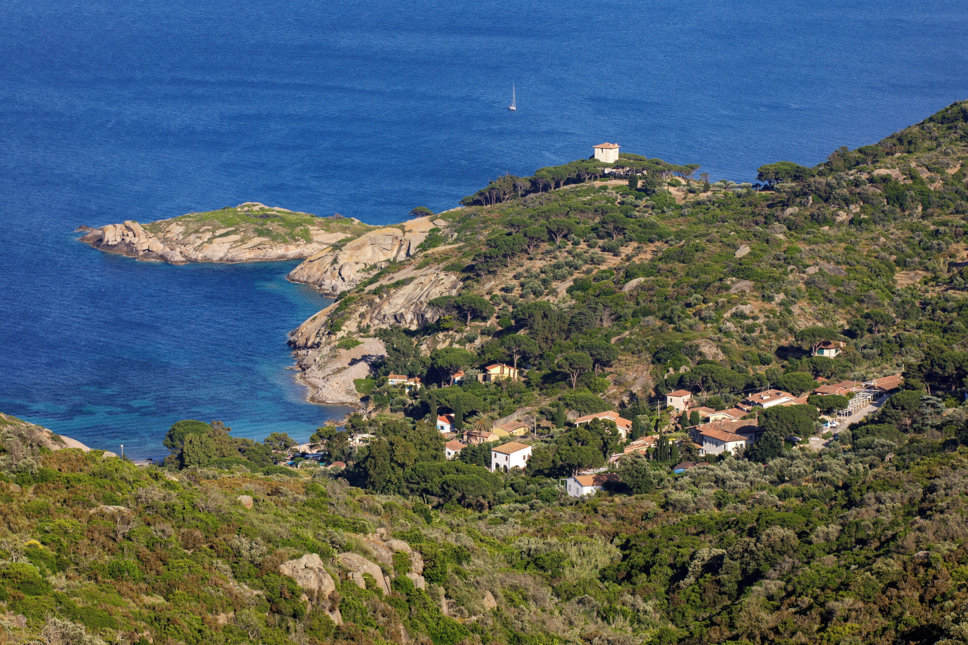 Un village côtier avec des maisons construites sur une colline, d’où l’on a une vue sur la mer.