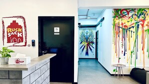An office reception area with a black door marked "Office" and a sign indicating "Ruck Sack Only". - Rucksack Inn Tyrwhitt Road (Singapore)