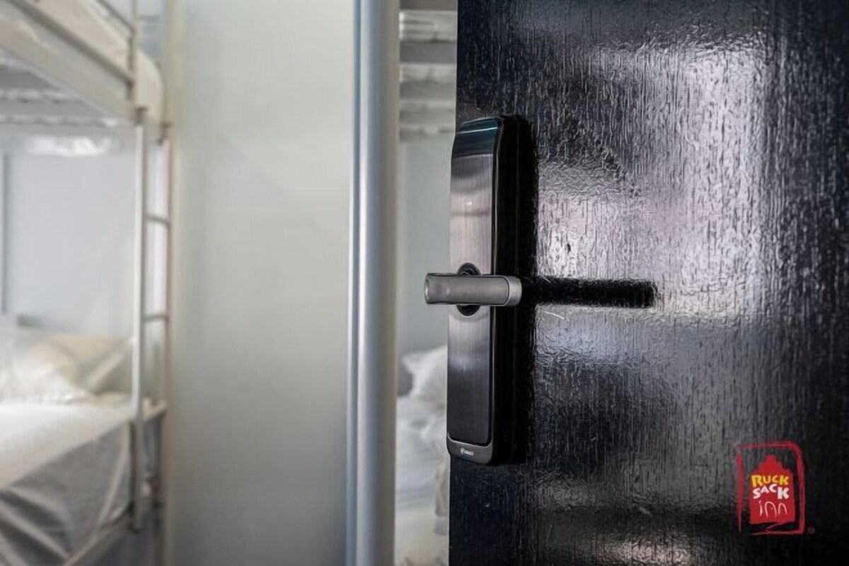 A door with a digital lock and a sticker of a restaurant.