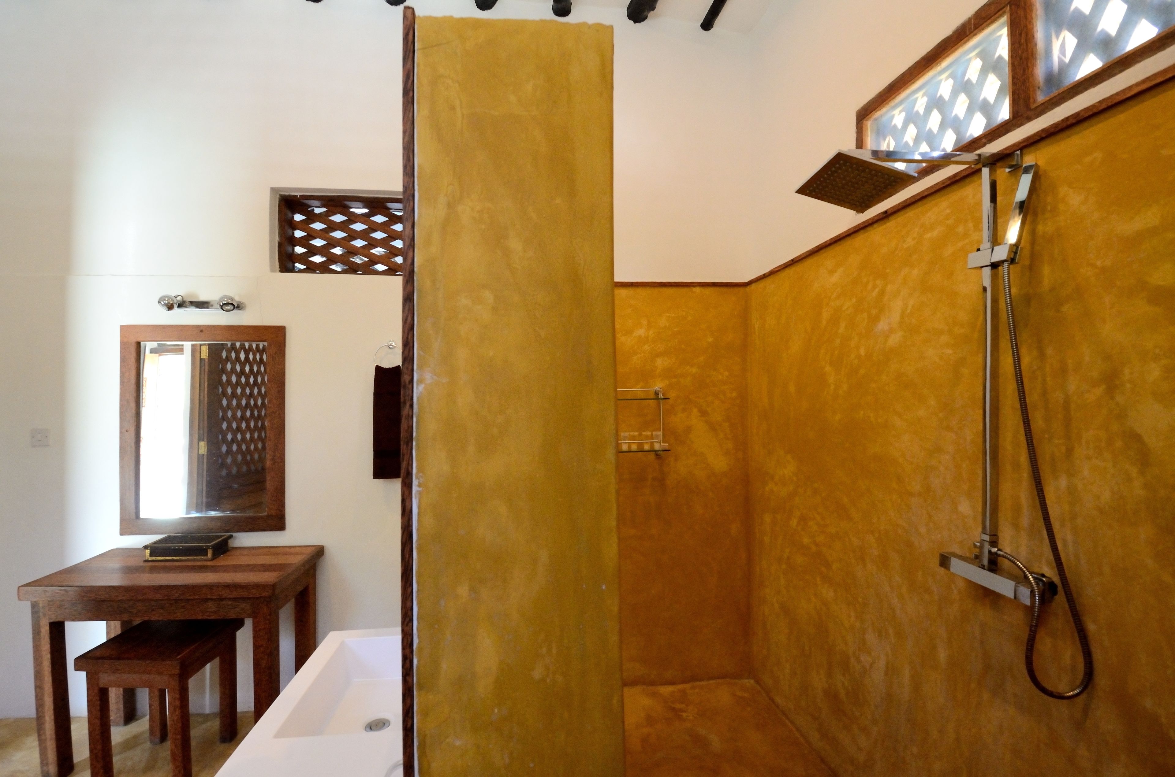 Un baño con bañera, ducha y tocador con espejo.