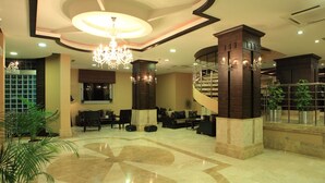 A spacious lobby with a grand chandelier, a central seating area, and a spiral staircase. - Rescate Boutique Hotel Ankara (Ankara)