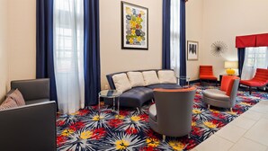 A modern living room with a sofa, armchairs, and a patterned rug. - Best Western Inn (Elyria)
