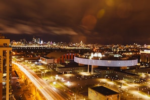 A nighttime cityscape with a prominent building featuring a unique, illuminated structure. - ibis Astana (Astana)