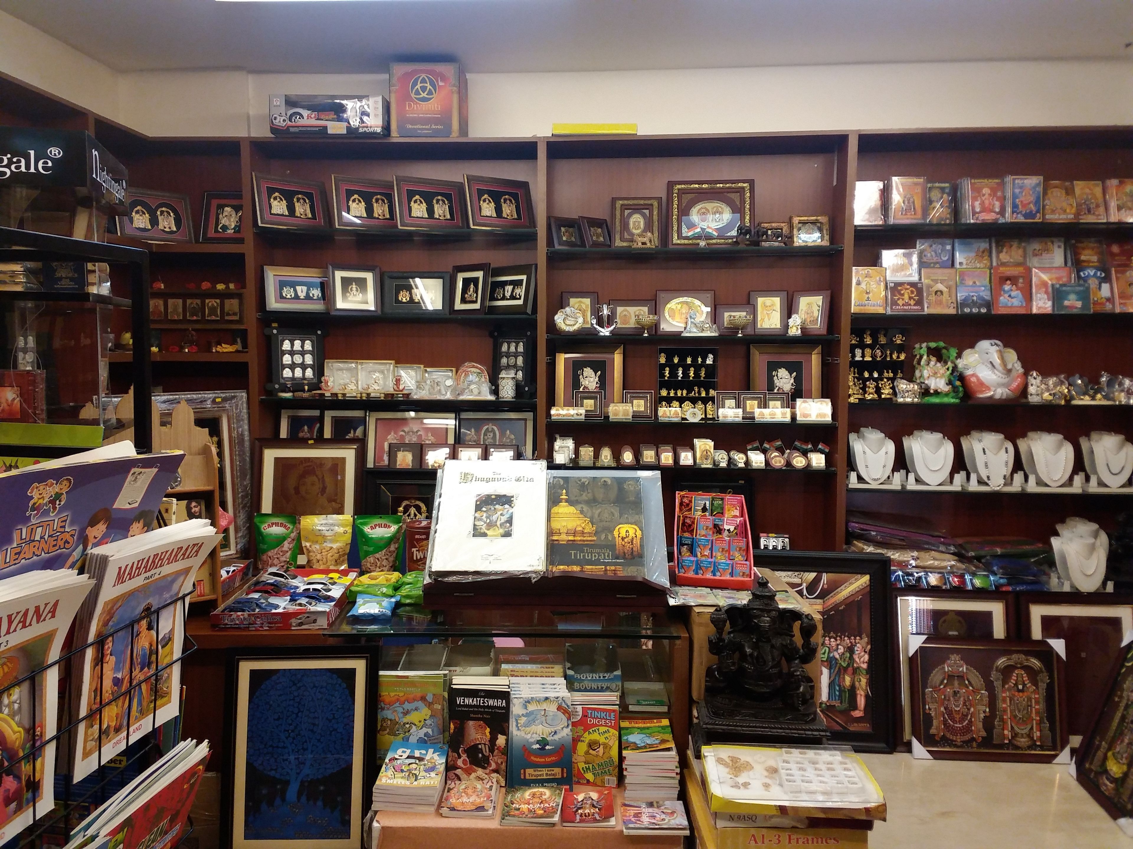 A bookstore with shelves of books, DVDs, and framed pictures.