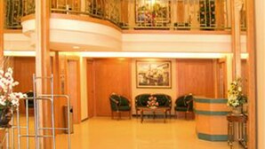 A spacious lobby with a polished floor, a reception desk, and seating areas. - Hotel Regal Malaysia (George Town)