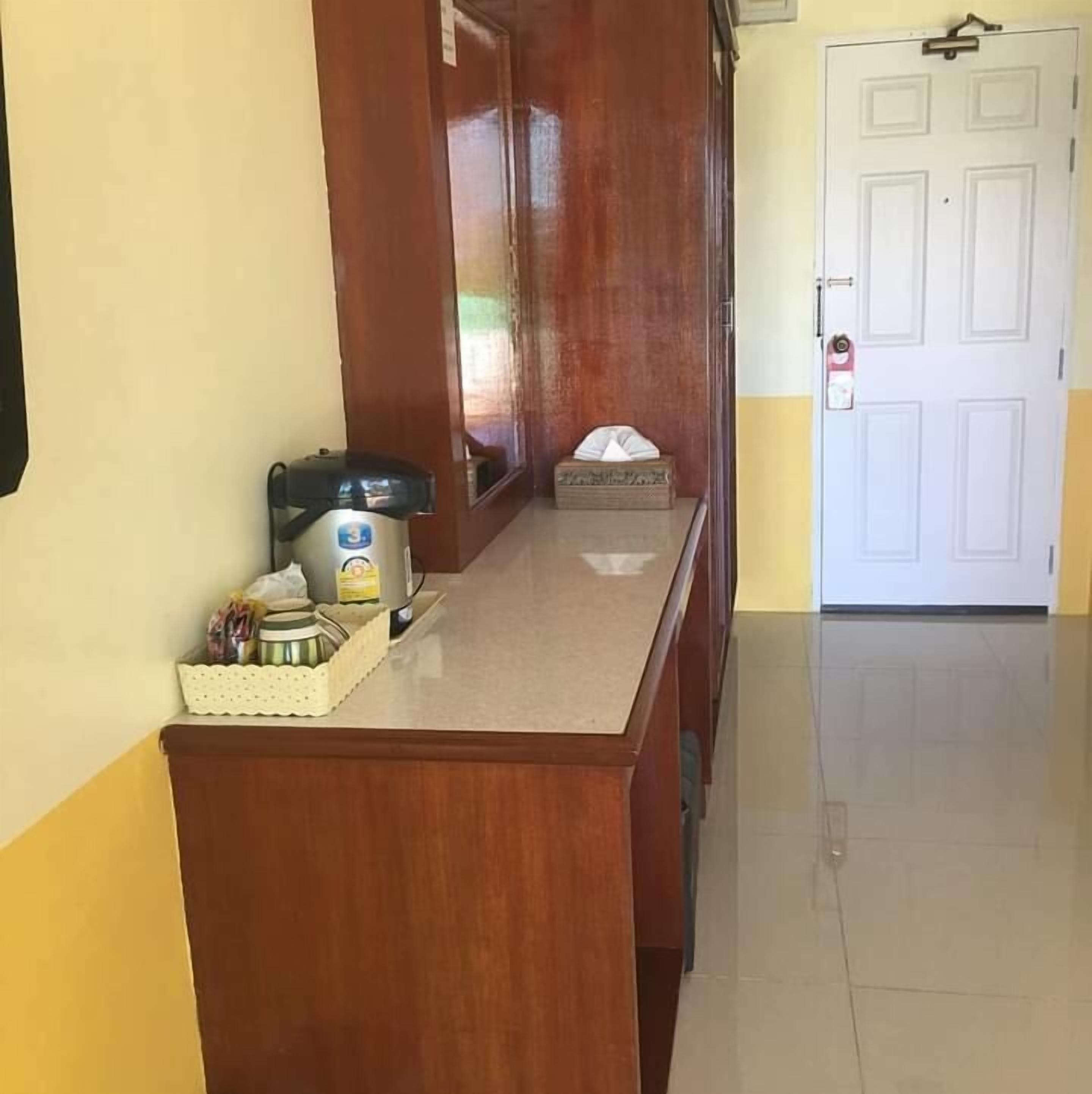 A hallway with a wooden counter, a water dispenser, and a small box.