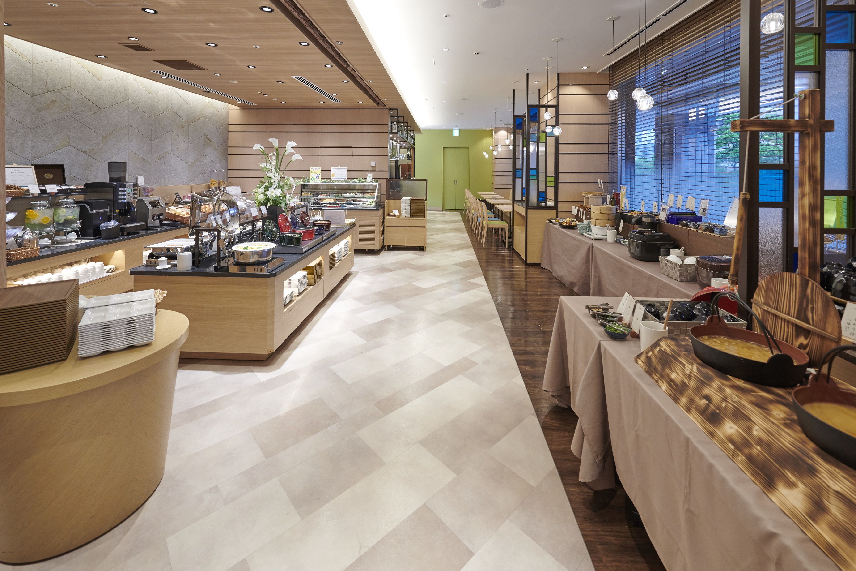 A buffet area with a variety of food items and a coffee station.
