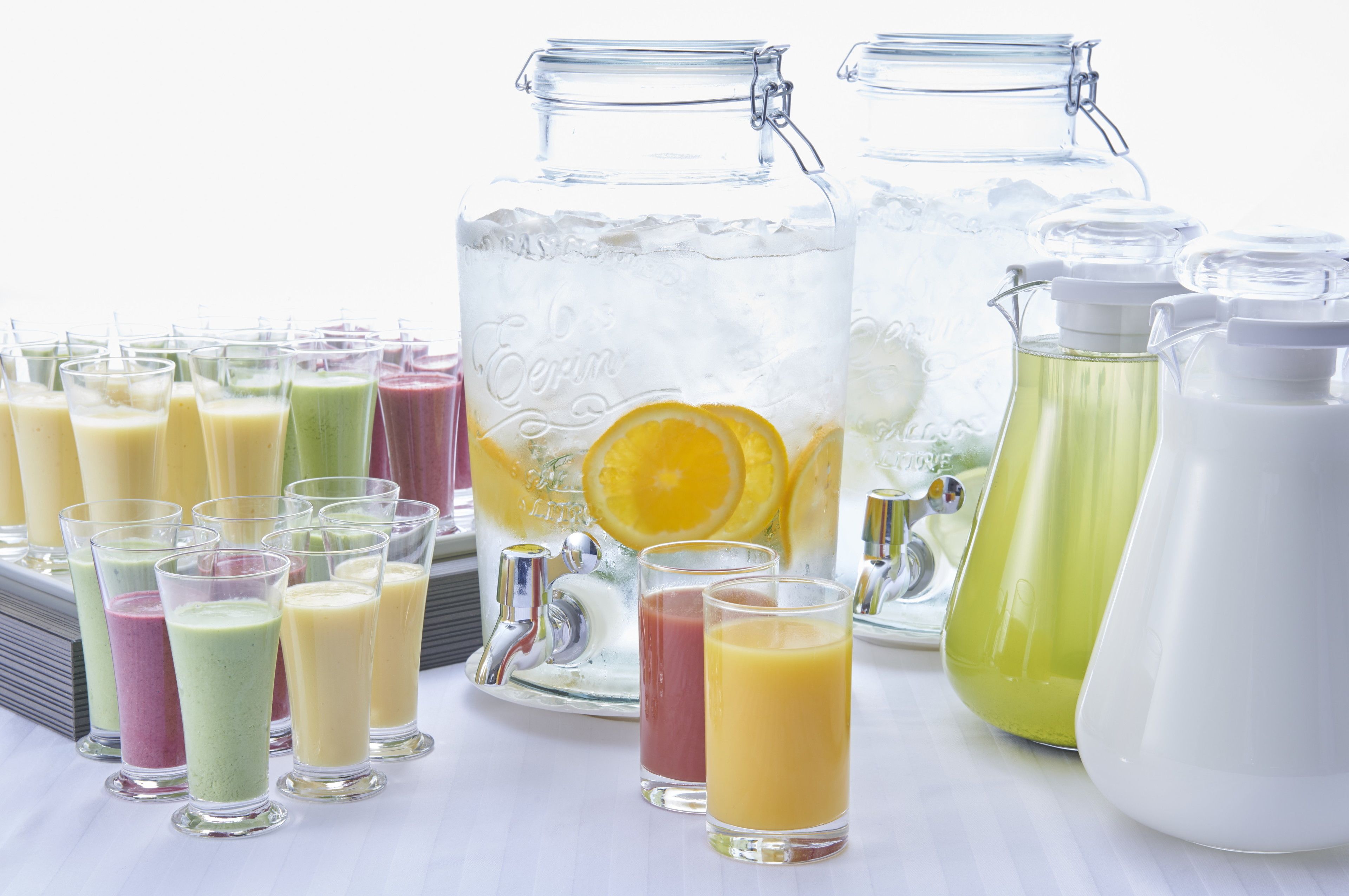 A variety of colorful beverages in glasses and pitchers, suggesting a refreshment setup.