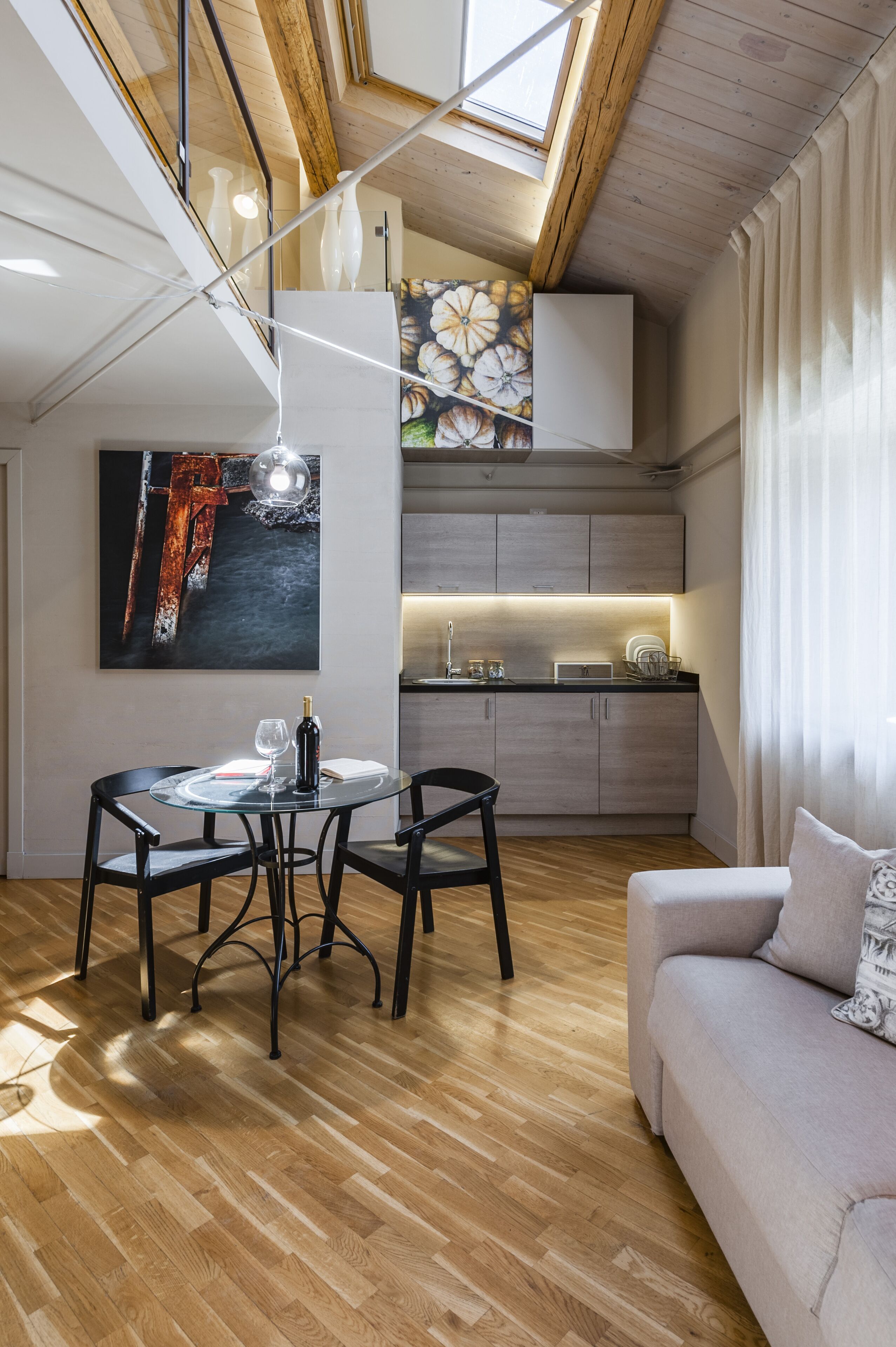 A modern interior with a dining area, a sofa, and a kitchen.