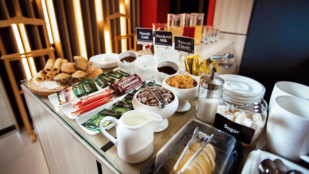 A breakfast buffet with various food items and beverages.