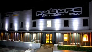 A modern hotel exterior with a prominent sign reading "PUBO".