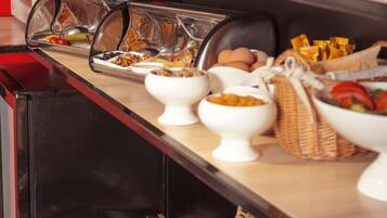 A buffet setup with various food items and condiments.