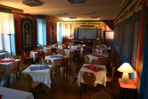 Enjoy meals in a beautifully appointed dining area with ornate columns and elegant table settings.