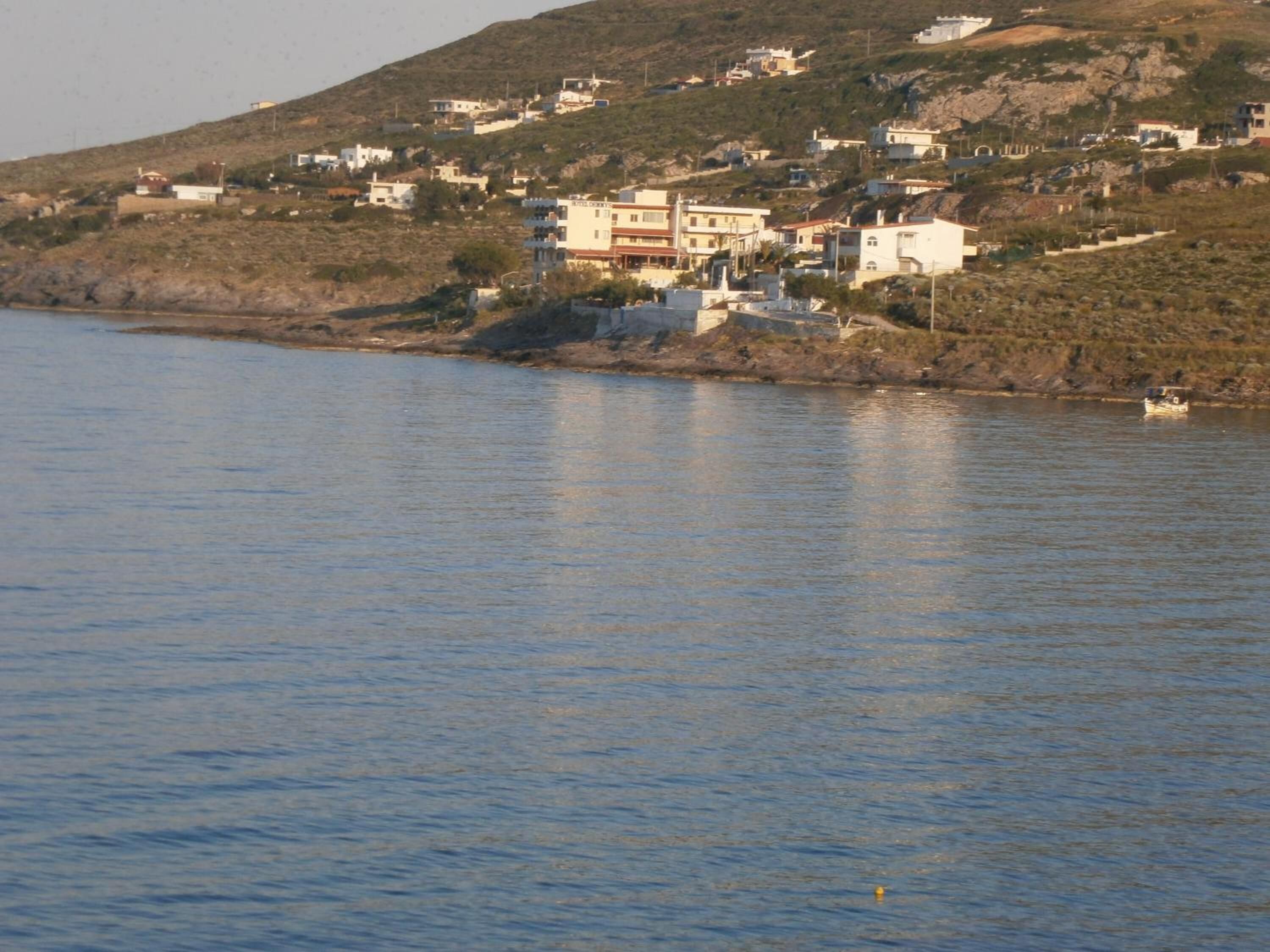 A coastal town with buildings along the shoreline.