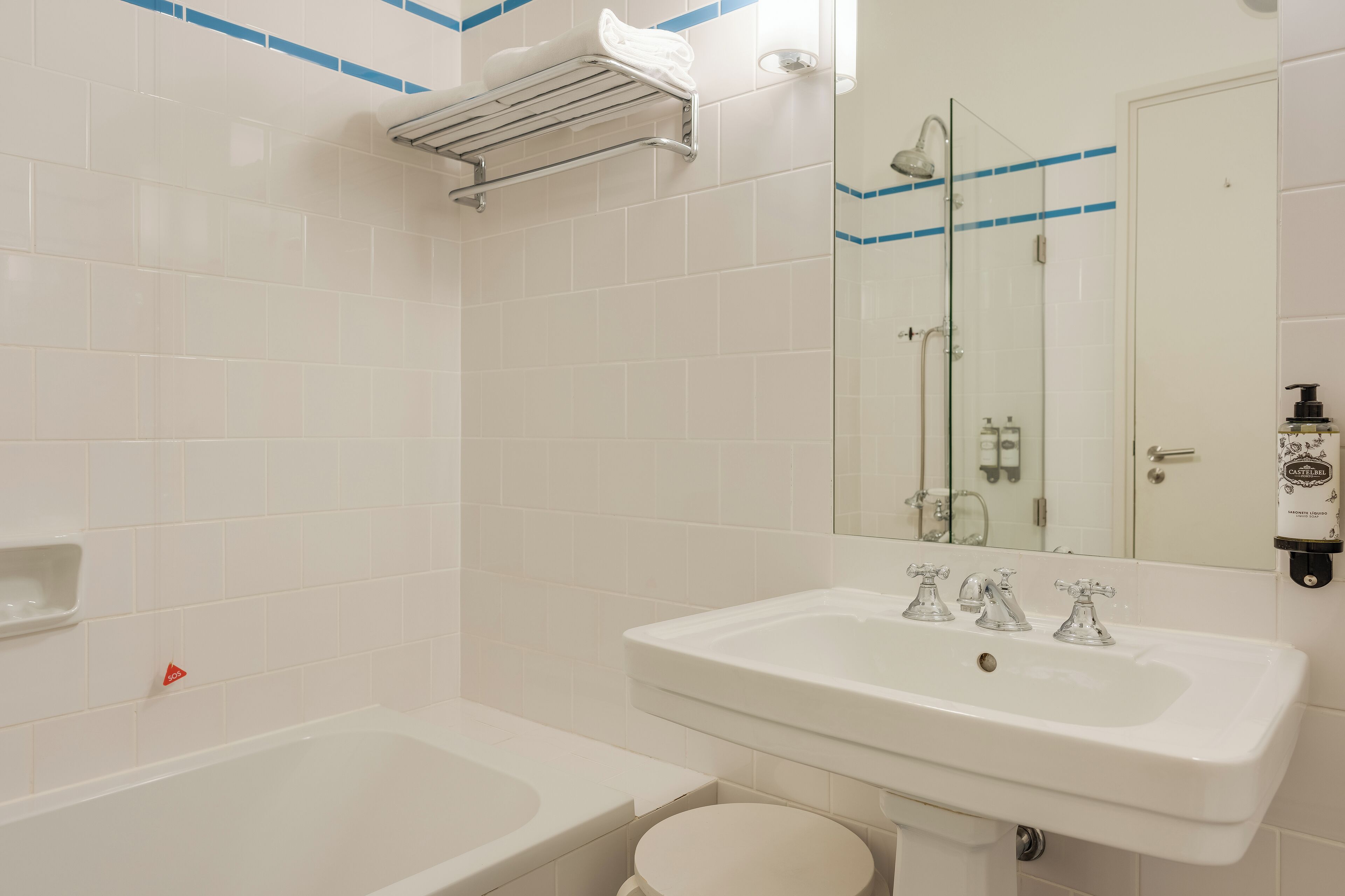 A bathroom with a bathtub, a sink, and a toilet.