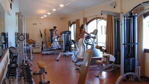 A gym with treadmills, stationary bikes, and weight machines. - Il Borgo di Porto Corallo (Villaputzu)
