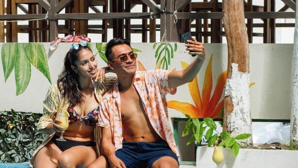 Two people sitting by a pool with a tropical mural in the background. - Hotel Maria Eugenia Tuxtla Gutierrez (Tuxtla Gutierrez)