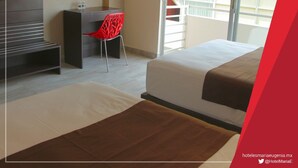 A hotel room with a bed, a desk, a red chair, and a TV. - Hotel Maria Eugenia Tuxtla Gutierrez (Tuxtla Gutierrez)