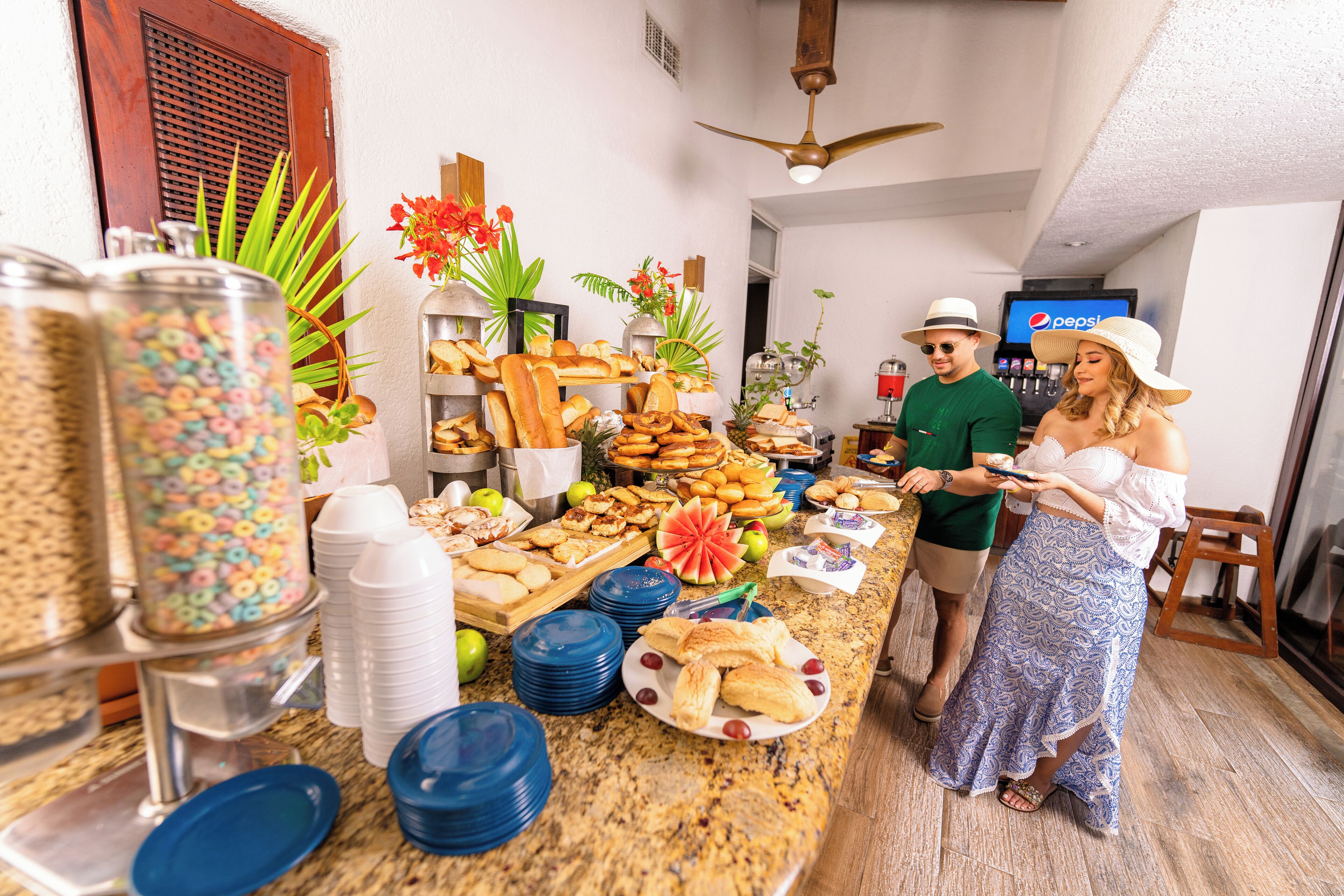 A buffet setup with various food items and beverages, including a Pepsi refrigerator.