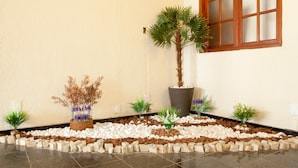 A landscaped area with potted plants and a tiled floor. - HMG Praia Suites for Rent (Rio de Janeiro)