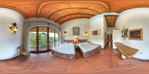 A spacious room with a large bed, a smaller bed, and a bench. There is a balcony with a view of greenery. - Hotel-Museo Posada de la Misón (Taxco)
