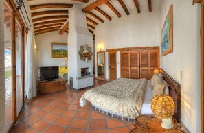 Laptop workspace, iron/ironing board, bed sheets