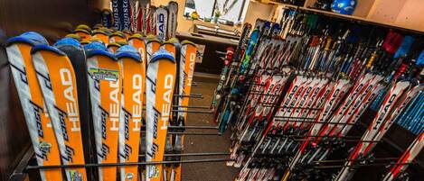A ski equipment store with rows of skis and ski poles.
