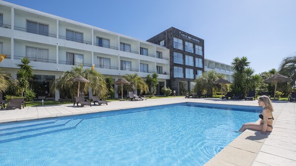 Piscine couverte, piscine extérieure, parasols de plage, chaises longues