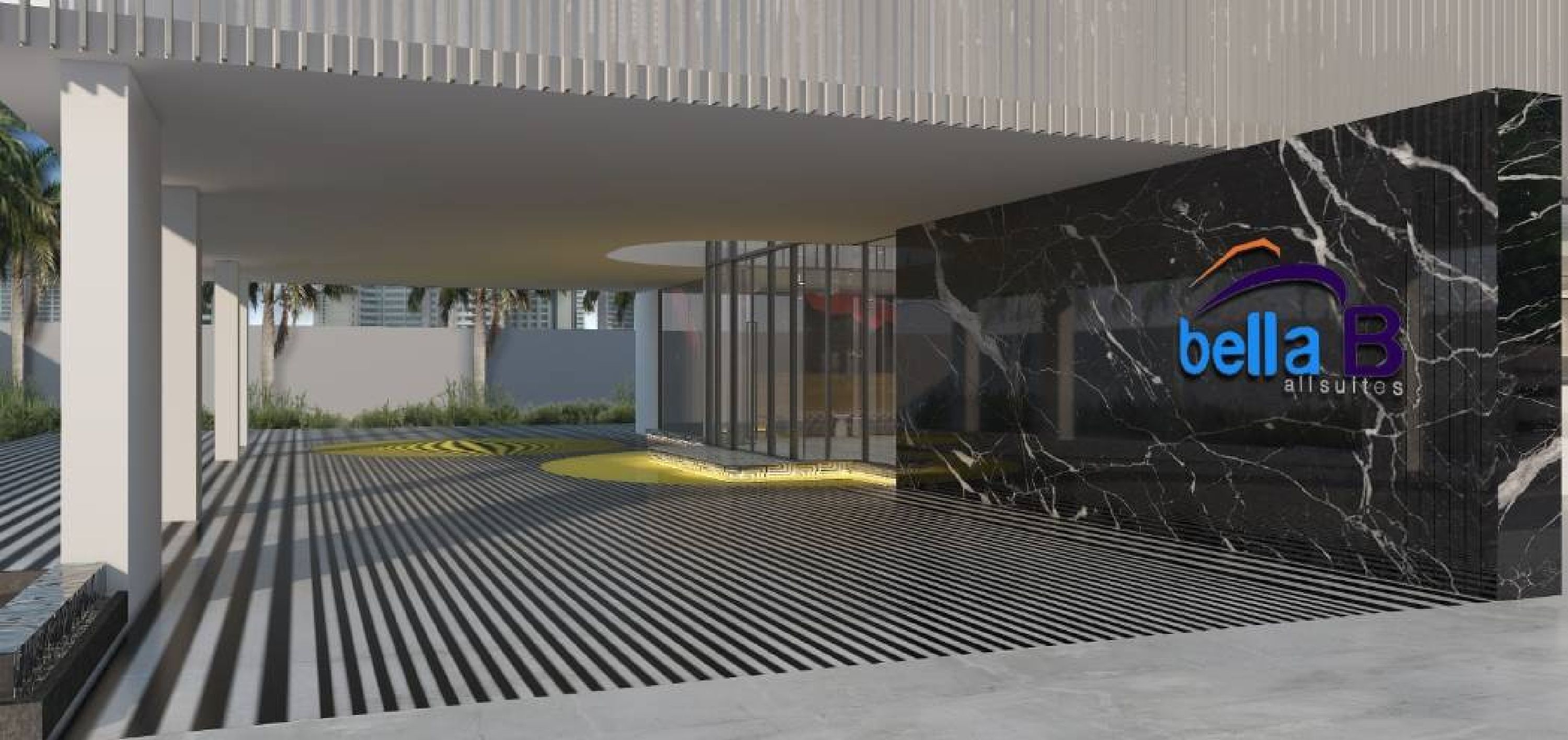 Entrada moderna de un edificio con fachada de vidrio y pared con textura de mármol que muestra el logotipo "bella B all suites".