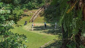 Stroll through the lush fairway, surrounded by dense foliage, and enjoy the serene natural setting.