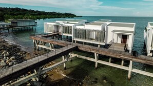 A coastal hotel with overwater bungalows connected by wooden walkways. - Cove 55 (Kuching)