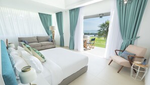 A modern hotel room with a large bed, a sofa, a chair, and a balcony with a view. - Cove 55 (Kuching)