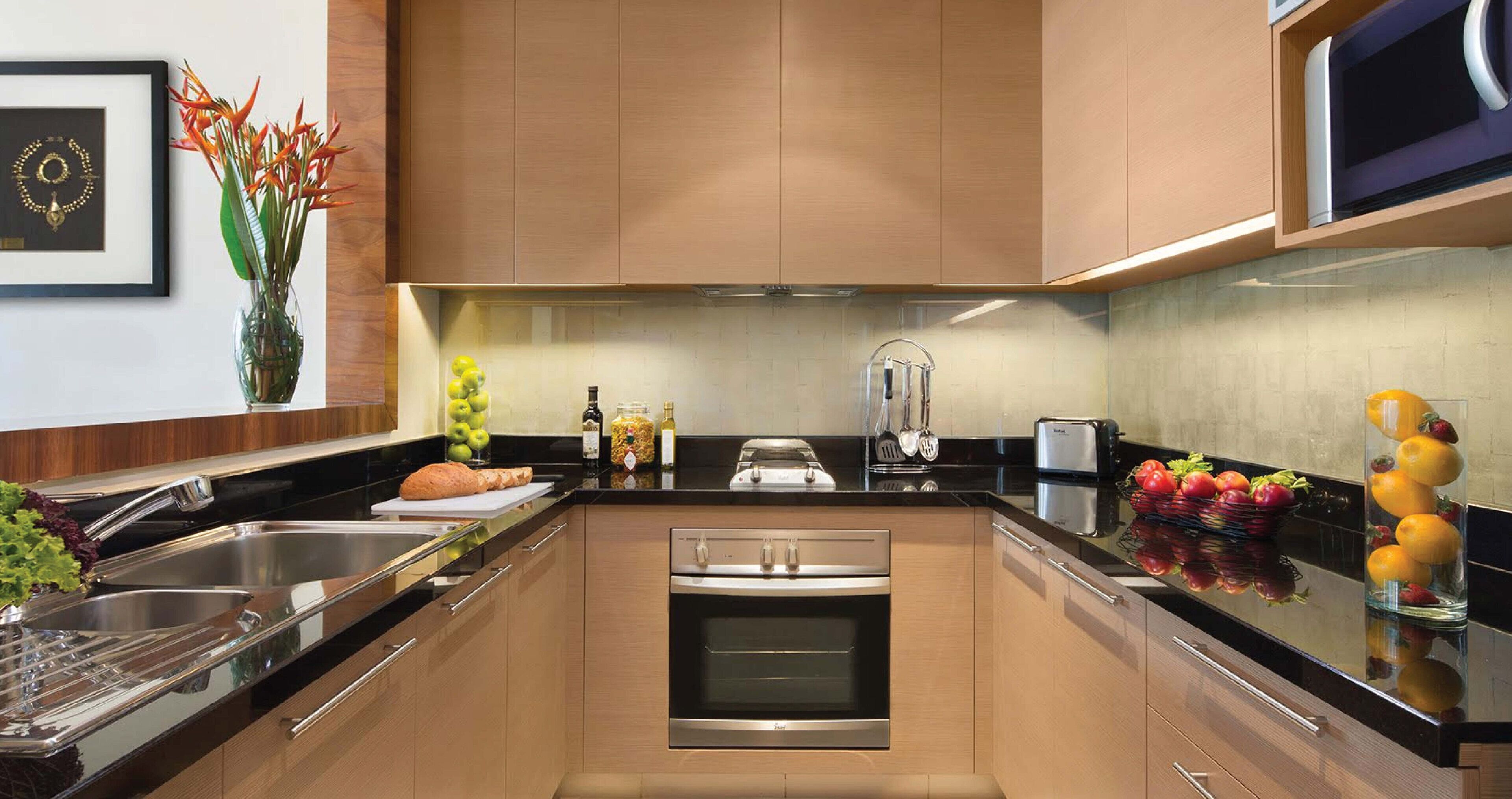 A modern kitchen with stainless steel appliances, wooden cabinets, and a central island.