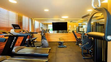 A gym with treadmills, stationary bikes, and weight machines.