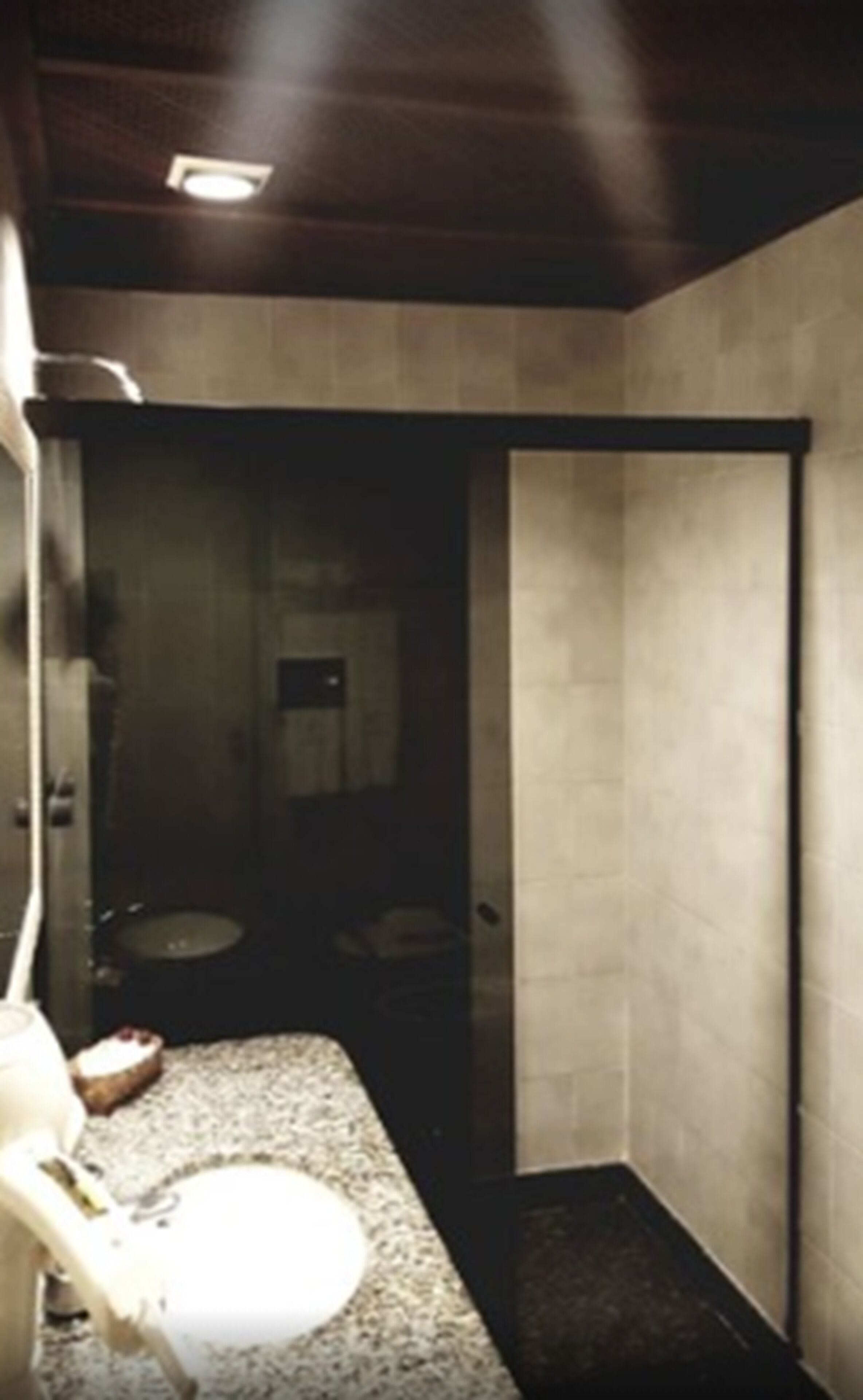 A small bathroom with a toilet, sink, and mirror.