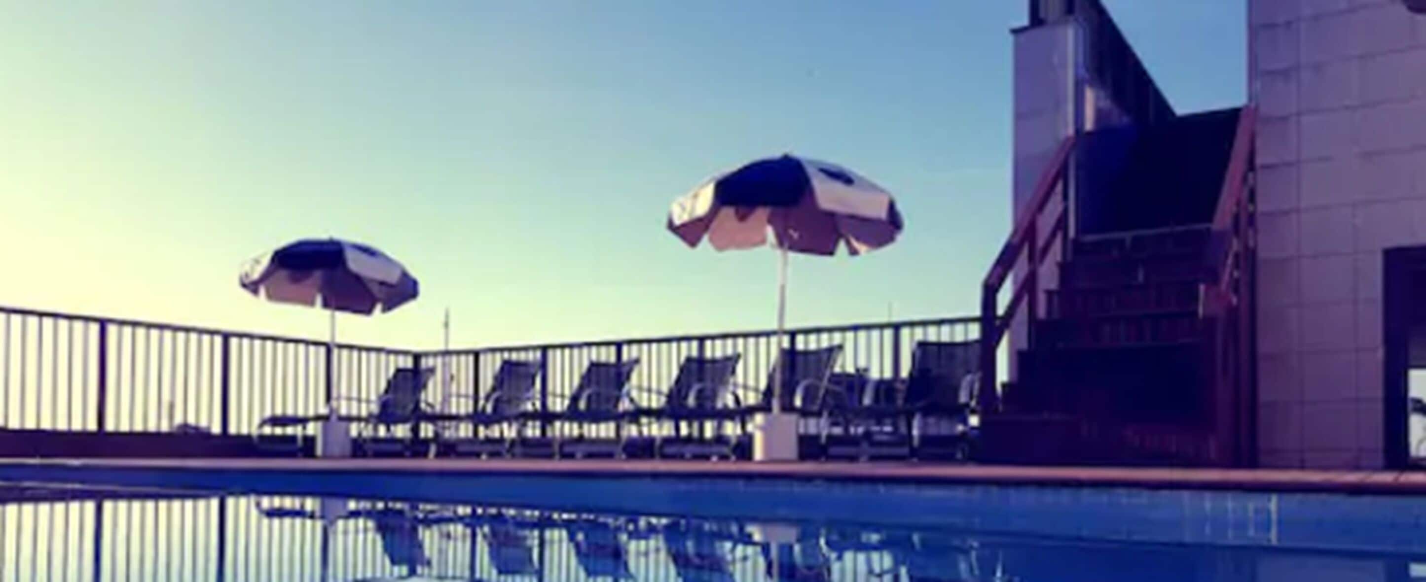 Outdoor pool, open 9 AM to 4:00 PM, pool umbrellas