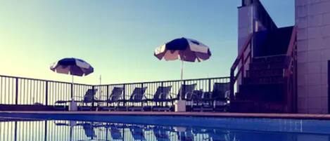 Outdoor pool, open 9 AM to 4:00 PM, pool umbrellas