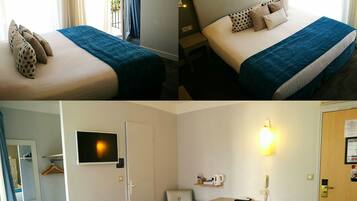 Ein Hotelzimmer mit Bett, Schreibtisch, Stuhl und Fernseher.
