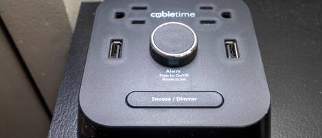 A black device with a central button and two side vents, labeled 'cabibtime' and 'Alarm' with instructions for use.