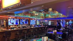 A casino interior with multiple gaming tables, chairs, and slot machines. - Prospector Hotel & Gambling Hall (Ely)