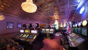 A casino with multiple slot machines and a bar area. - Prospector Hotel & Gambling Hall (Ely)