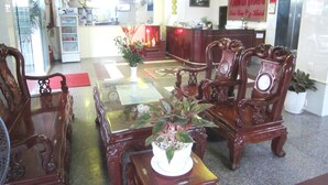 A hotel lobby with a reception desk, a clock, and a large clock above the desk. - Thanh Hong Hotel (Ho Chi Minh City)
