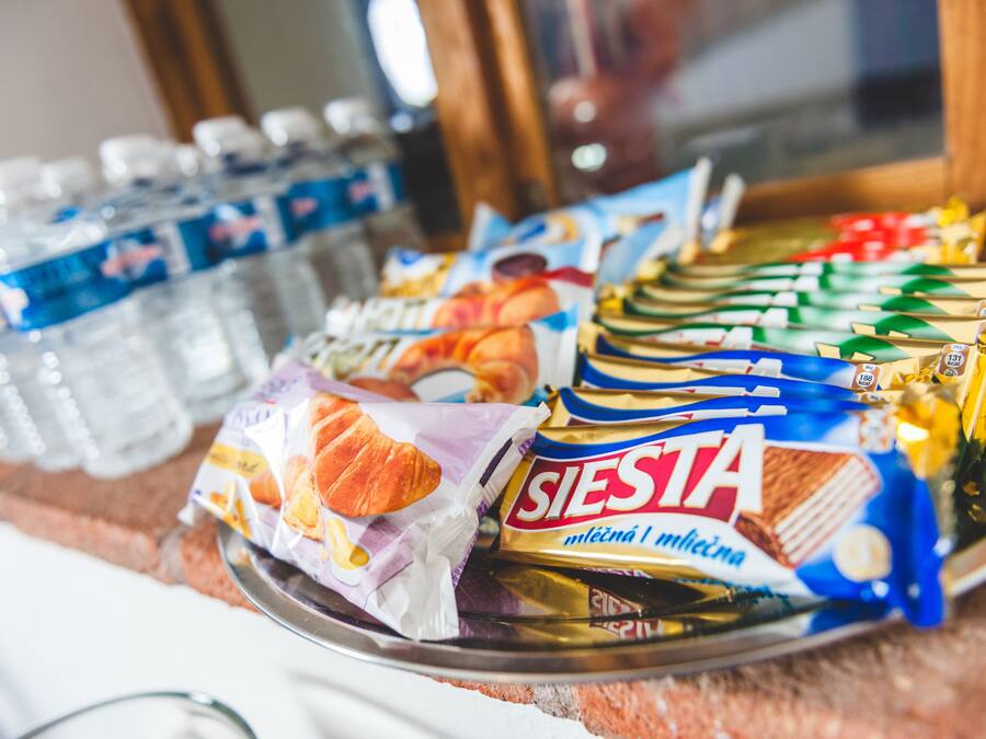 A tray with various food items including packaged snacks and bottled water.