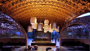 An interior with a high ceiling, wooden furniture, and hanging light fixtures. - Veranda Chiang Mai Suite (Hang Dong)