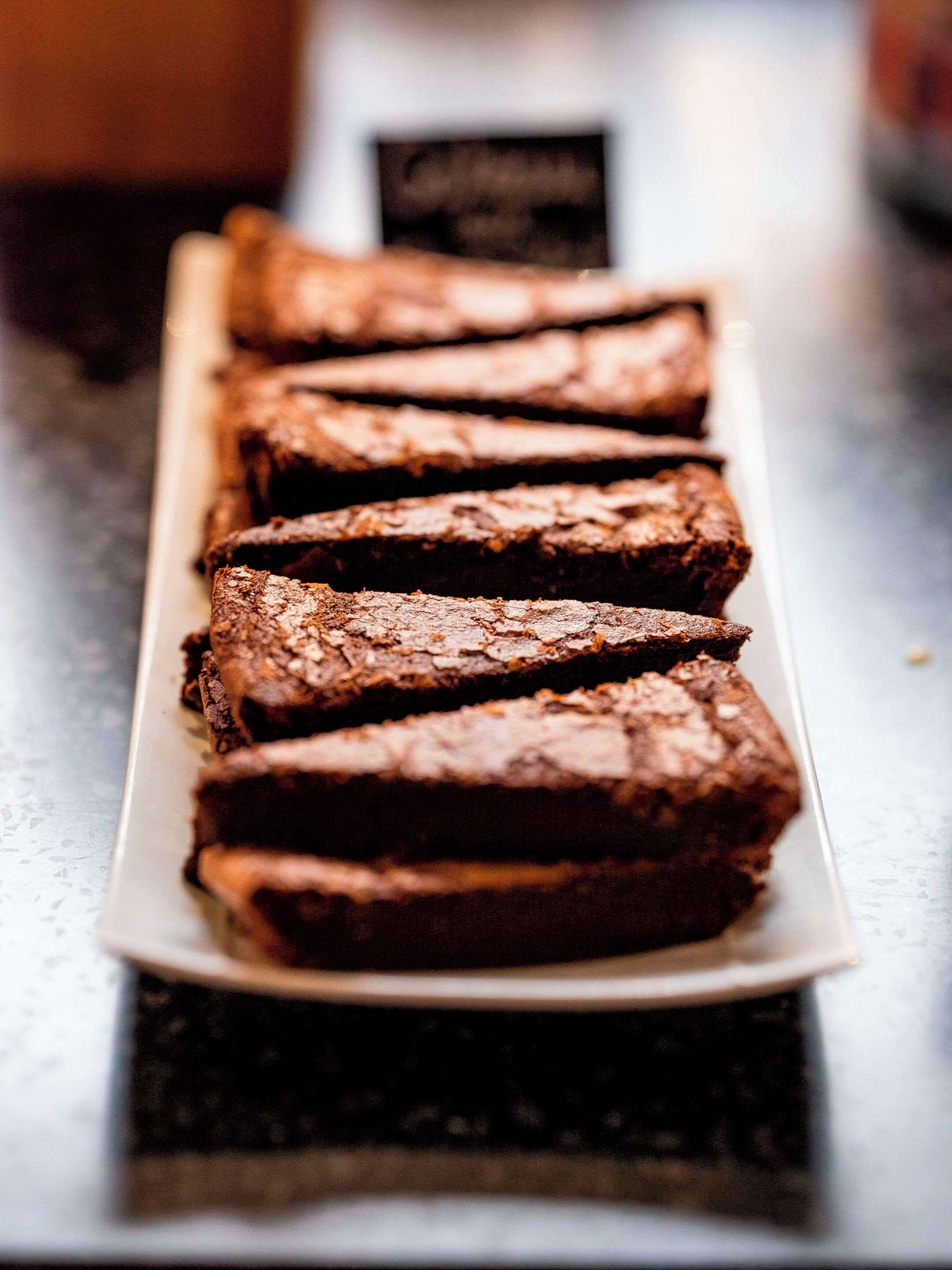A tray of brownies on a white plate.
