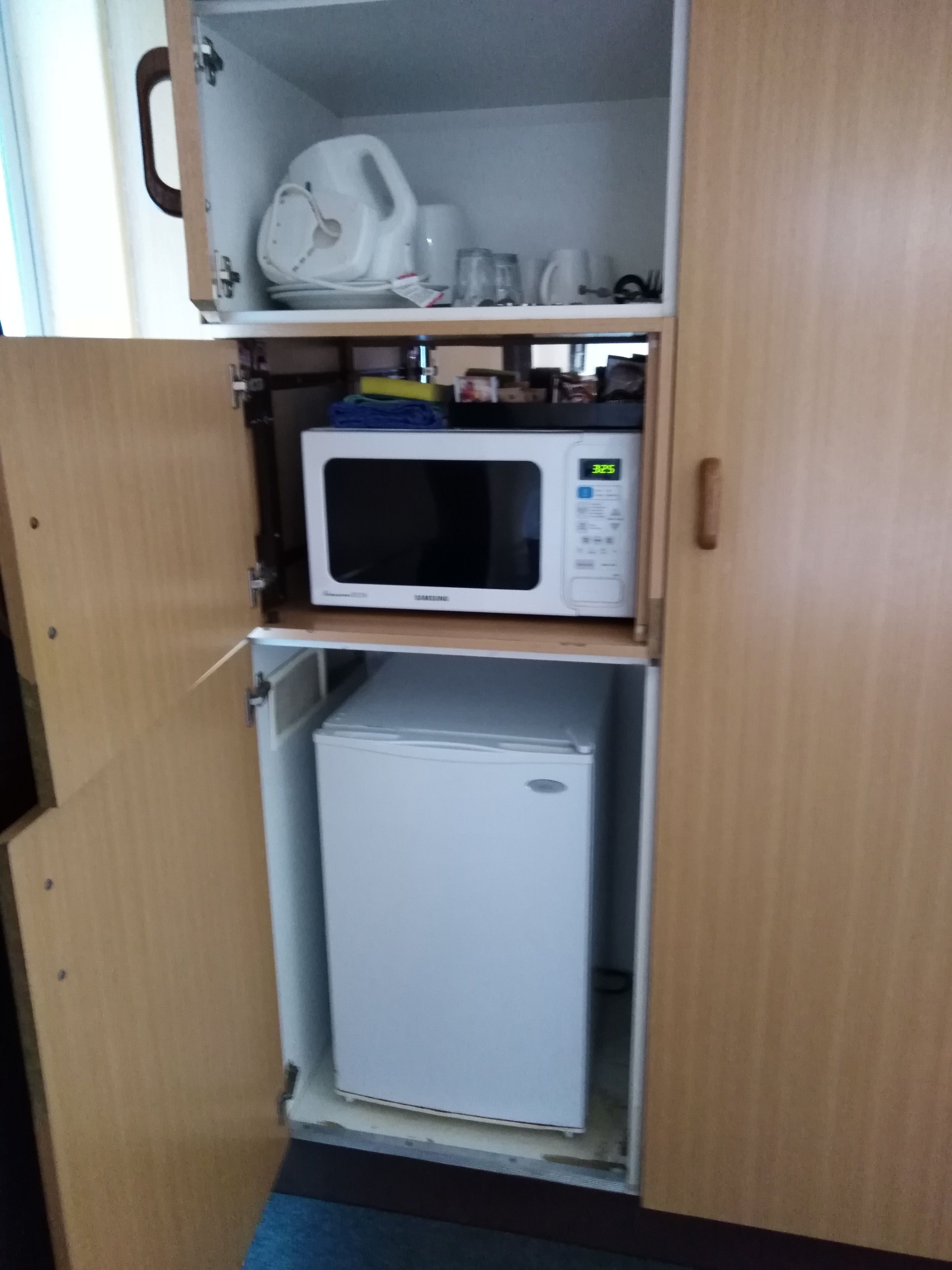 A compact kitchen with a microwave and a mini-fridge.