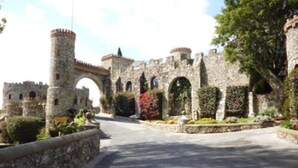 A stone castle with arched walkways and a central archway.