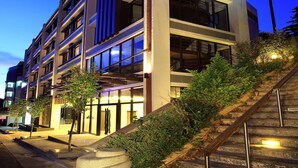 A multi-story building with a modern architectural design, featuring a staircase leading to the entrance. - Lealea Garden Hotel Moon (Yuchi)